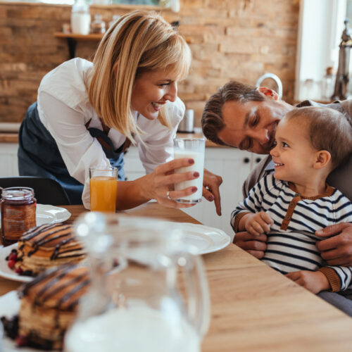 Adorable family having breakfast at home