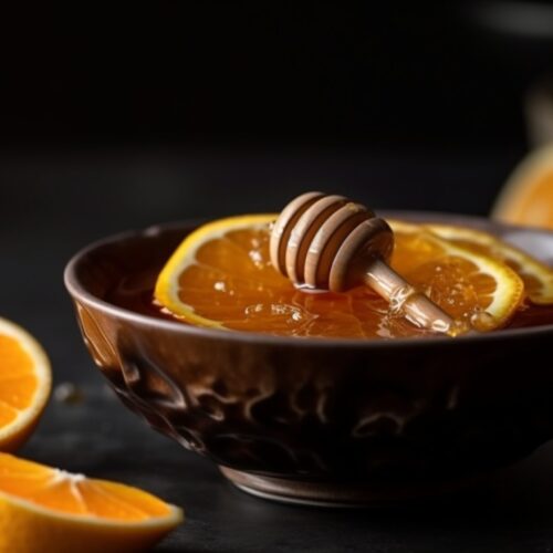 Close-up honey bowl with orange slices
